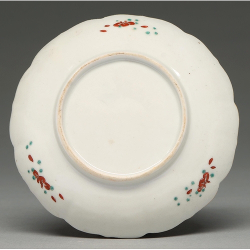 343 - A Chinese fluted saucer with Kakiemon-style decoration, 18th c, enamelled with a prunus and pine gro... 