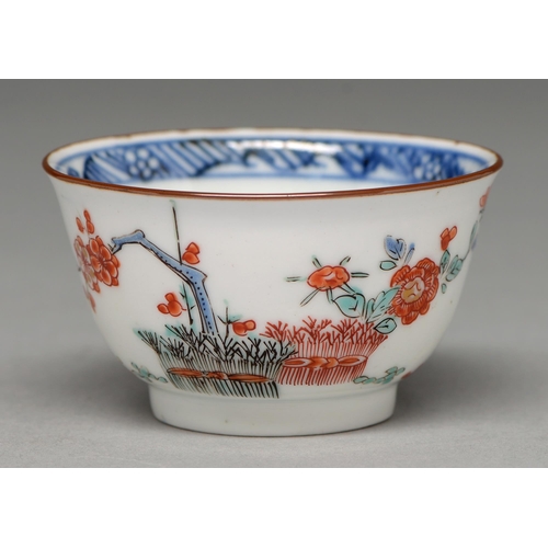 344 - A Kakiemon cup, Edo period, early 18th c, enamelled with banded hedge and blossoming prunus and othe... 