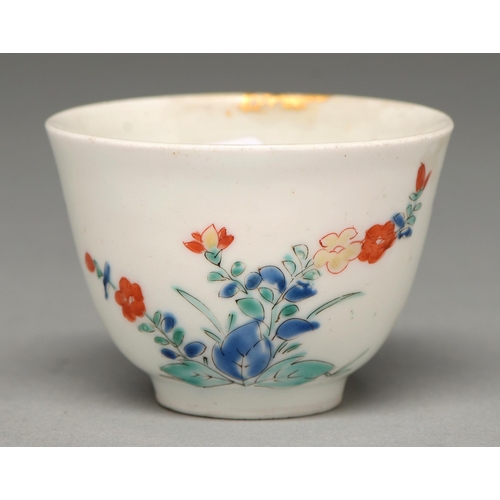 345 - A Kakiemon cup, Edo period, c1700, with rounded sides and slightly everted lip, enamelled with two c... 