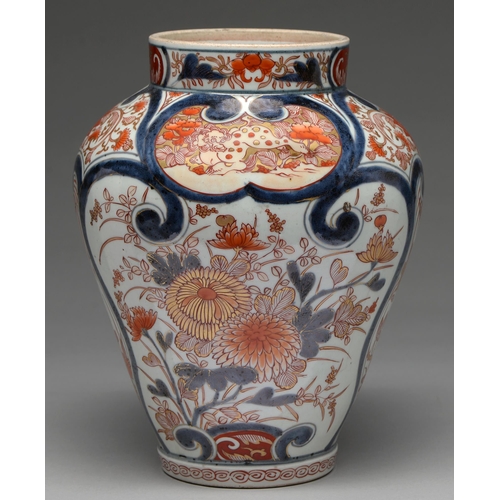 349 - An Imari jar, Edo period, 18th c, painted in underglaze blue with fan shaped panels of chrysanthemum... 