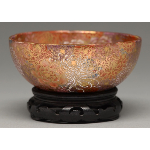 369 - A Satsuma ware bowl, early 20th c, enamelled with chrysanthemums and peony on a firey red ground, 15... 