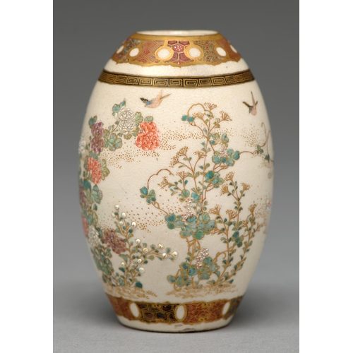 373 - A Satsuma ware drum shaped vase, Meiji period, enamelled and gilt with naturalistic flowering plants... 