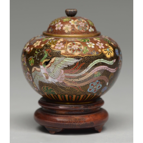 384 - A Japanese cloisonne enamel jar and cover, enamelled with two phoenix beneath overlapping floral bor... 