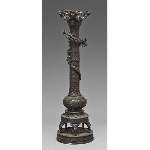 400 - A Japanese bronze candle stand, Meiji period, a dragon entwined around the pillar, the bulbous base ... 