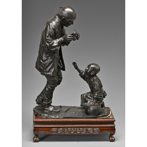 406 - A Japanese bronze sculpture of a man and his small son with Noh mask and drum, Meiji period, even ri... 