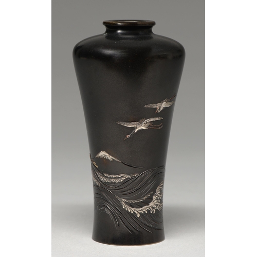 440 - A Japanese bronze vase, Meiji period, carved and inlaid in gold and silver above a surging sea with ... 