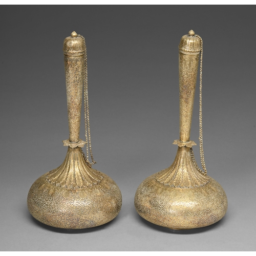 447 - A pair of brass flasks and chained stoppers, North India, 19th c, chased with foliage, the onion sha... 