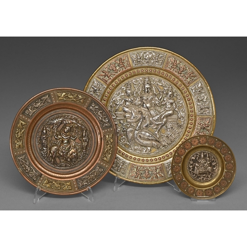 460 - Three Indian ornamental brass dishes, 19th c, with applied silver and cast and chased brass decorati... 