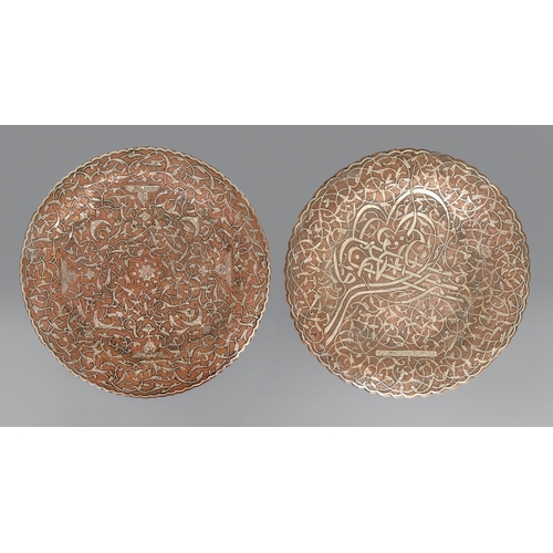 471 - Two brass Cairo ware plates, Egypt or Syria, 19th c, with applied silver decoration, one on three fe... 