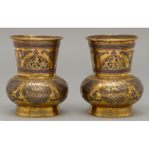 472 - A pair of brass Cairo ware vases, with pierced neck and applied silver and copper decoration and cal... 