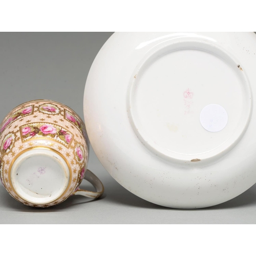 516 - A Derby coffee cup and saucer, c1795, painted with reserves of roses on a salmon pink ground, saucer... 