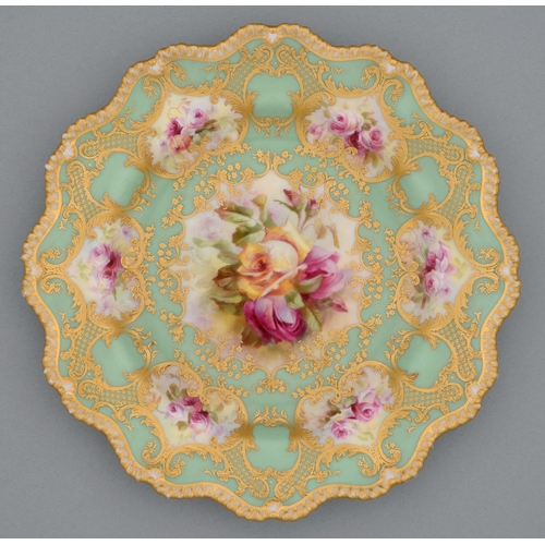 546 - A Royal Worcester plate, c1917, painted by Roberts, signed, with two or three pink and yellow roses ... 