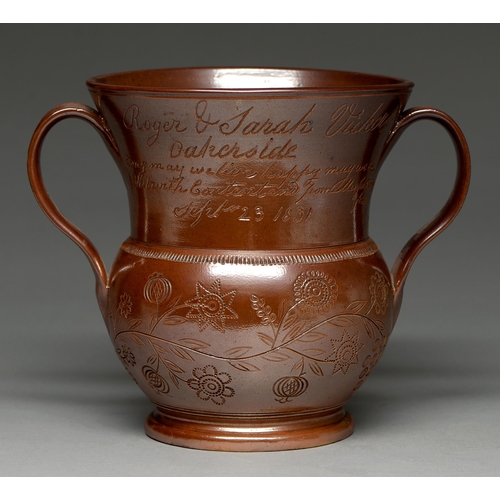 566 - A Derbyshire saltglazed brown stoneware jug, probably Chesterfield, dated 1831, incised on the flare... 