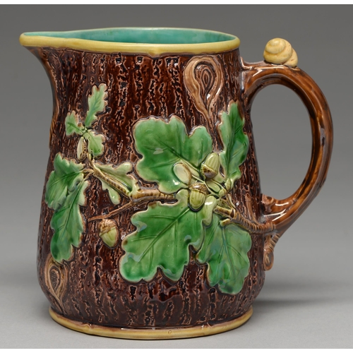 579 - A Minton majolica rustic jug, 1866, moulded with oak leaves and acorns, the handle with a snail shel... 