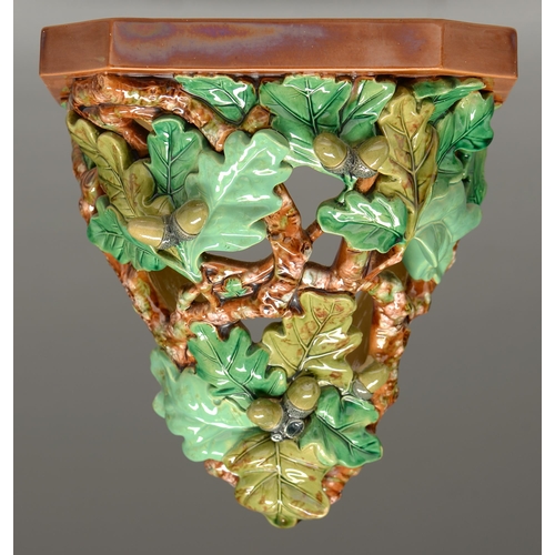 580 - A William Brownfield majolica wall bracket, c1877, the shelf supported by entwined open oak boughs w... 