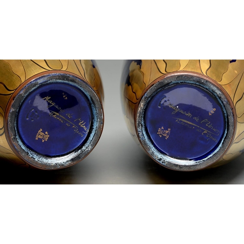 597 - A pair of French cobalt blue and gilt porcelain vases, 20th c, with a ribbon bow, laurels and flower... 