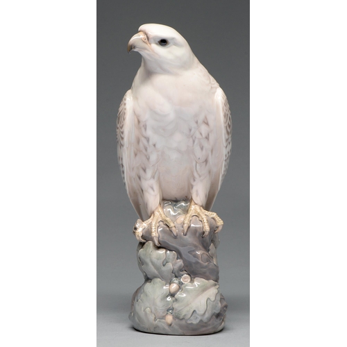 604 - A Royal Copenhagen porcelain model of an eagle, 20th c, perched on a rocky outcrop with oak leaves a... 