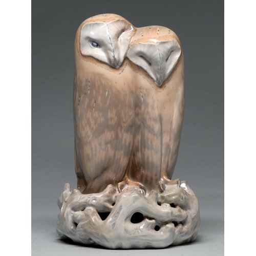 606 - A Royal Copenhagen porcelain group of two barn owls, c1938, on pierced perch of gnarled branches, 31... 