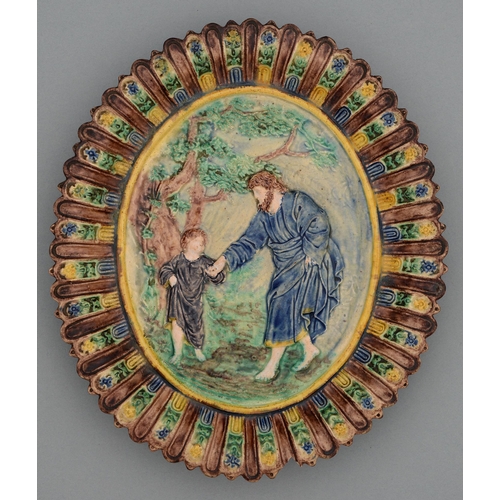 609 - A French Palissy ware oval dish, 19th c, moulded in relief with the Christ child and a saint, glazed... 