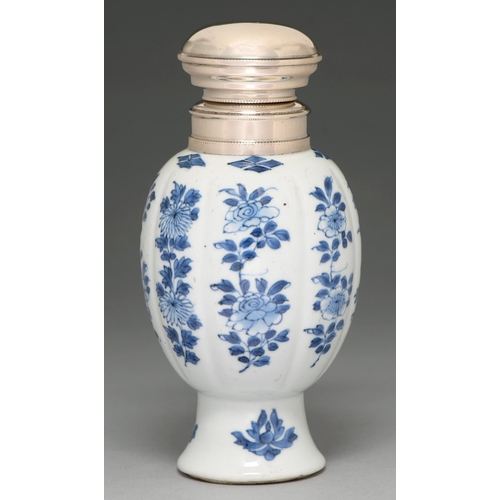 61 - A Chinese blue and white vase, 18th c, lobed ovoid on flared foot, painted with flowering plants, la... 