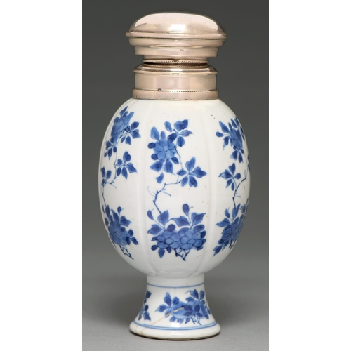 62 - A Chinese blue and white vase, 18th c, lobed ovoid on flared foot, painted with flowering boughs in ... 