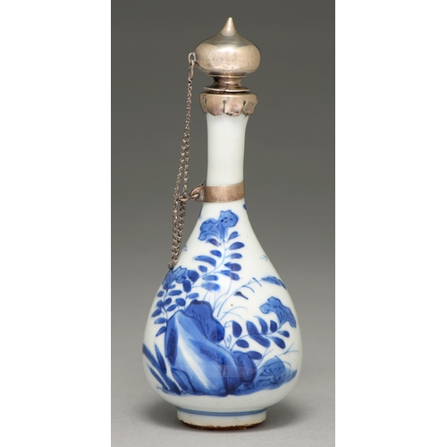 75 - A Chinese blue and white vase, 19th c, painted with flowers sprouting from rocks, later silver mount... 