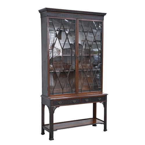 920 - An Edwardian mahogany cabinet, with dentil cornice and blind fret carved frieze, fitted with adjusta... 