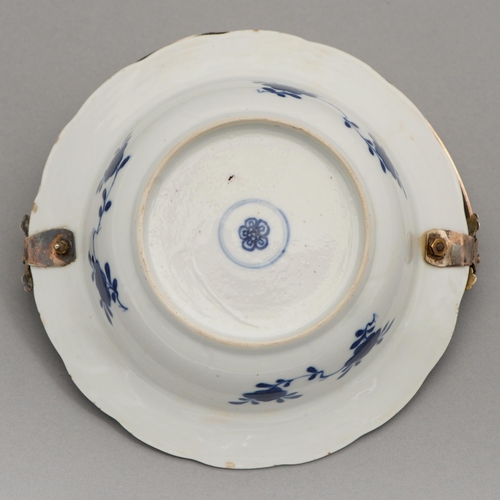 95 - A Chinese blue and white dish, 18th c, painted to the well with two flowering plants in lotus shaped... 