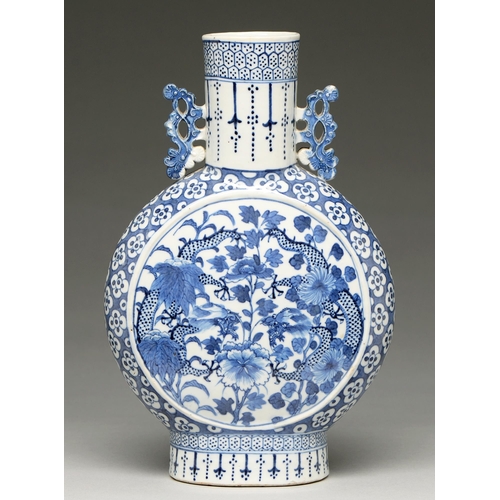 99 - A Chinese blue and white moon flask, 19th c, painted to either side with dragons and peony reserved ... 