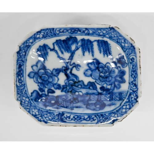 77 - A Chinese blue and white salt cellar, late 18th c, painted with peonies, tree and fence in panelled ... 