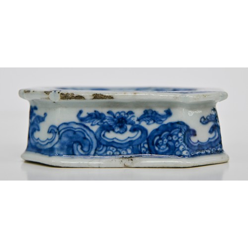 77 - A Chinese blue and white salt cellar, late 18th c, painted with peonies, tree and fence in panelled ... 