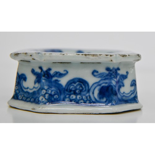 77 - A Chinese blue and white salt cellar, late 18th c, painted with peonies, tree and fence in panelled ... 