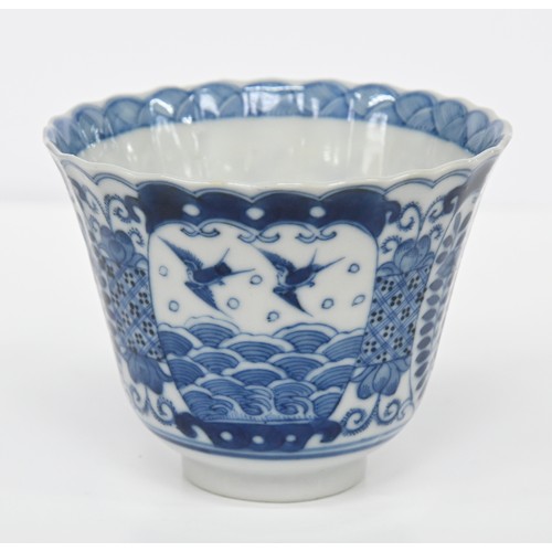 116 - A Chinese blue and white octagonal beaker, Kangxi period, painted in upright registers with flowerin... 