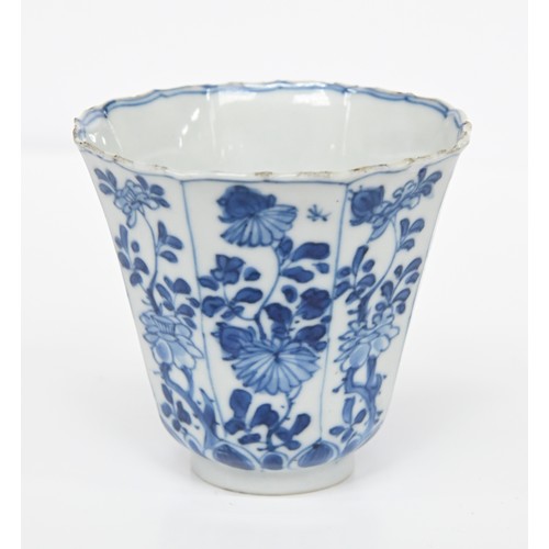 116 - A Chinese blue and white octagonal beaker, Kangxi period, painted in upright registers with flowerin... 