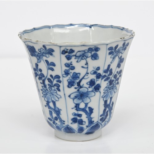 116 - A Chinese blue and white octagonal beaker, Kangxi period, painted in upright registers with flowerin... 