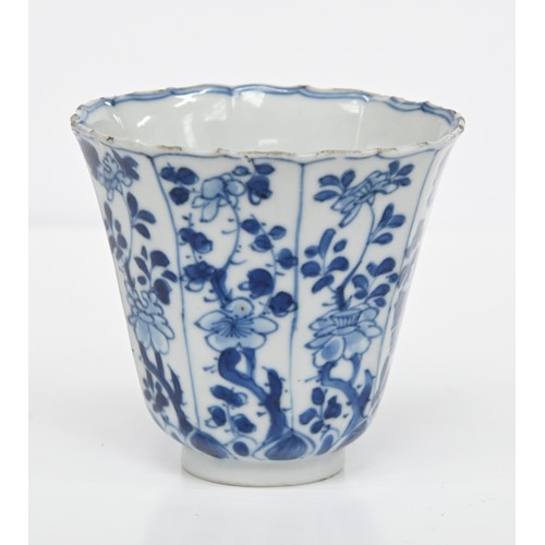 116 - A Chinese blue and white octagonal beaker, Kangxi period, painted in upright registers with flowerin... 