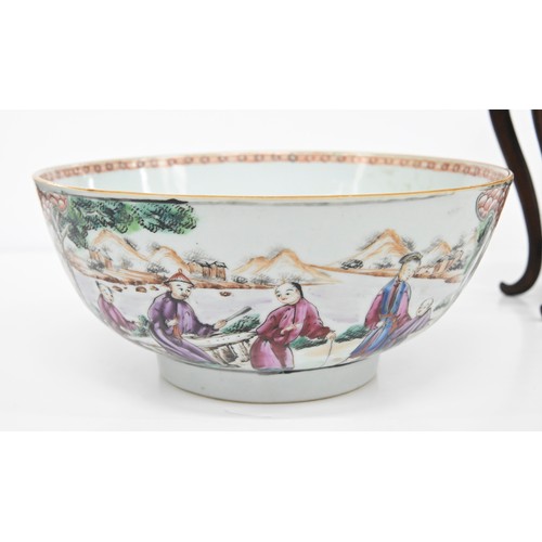 218 - A Chinese famille rose bowl, c1770, painted with two groups of figures by water in a mountainous lan... 