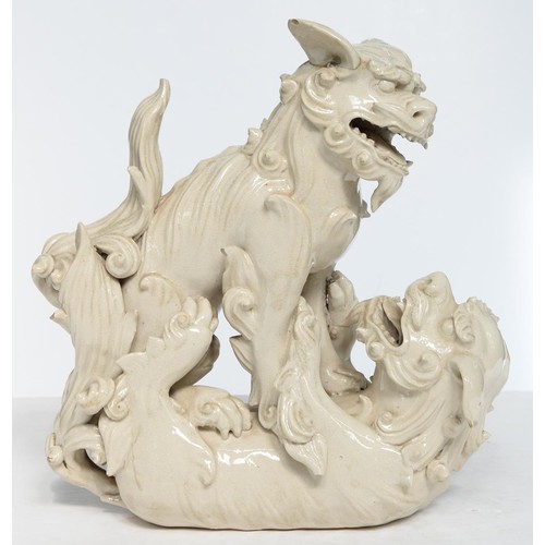 231 - A Chinese glazed porcelain group of fighting lion dogs, 19th c or later, 28cm h, wood stand carved w... 