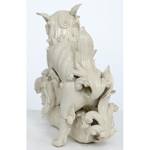 231 - A Chinese glazed porcelain group of fighting lion dogs, 19th c or later, 28cm h, wood stand carved w... 