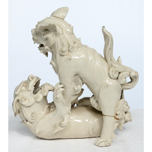 231 - A Chinese glazed porcelain group of fighting lion dogs, 19th c or later, 28cm h, wood stand carved w... 