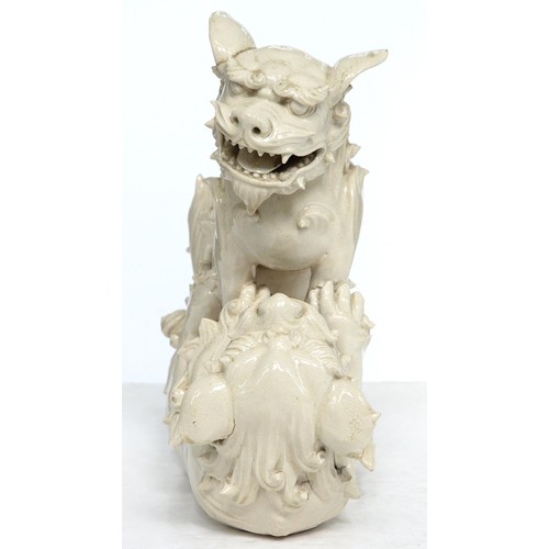 231 - A Chinese glazed porcelain group of fighting lion dogs, 19th c or later, 28cm h, wood stand carved w... 