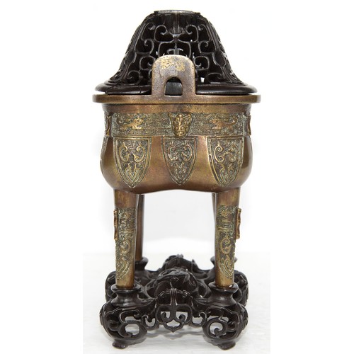 335 - A Chinese bronze archaistic vessel, Ding, 20th c, the sides cast with mask and stylised animals on k... 