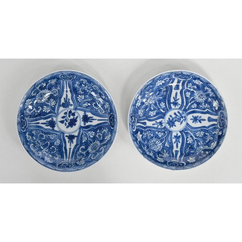 115 - A Chinese blue and white tea bowl and pair of saucers, Kangxi period, saucers 12.7cm diam, conch she... 