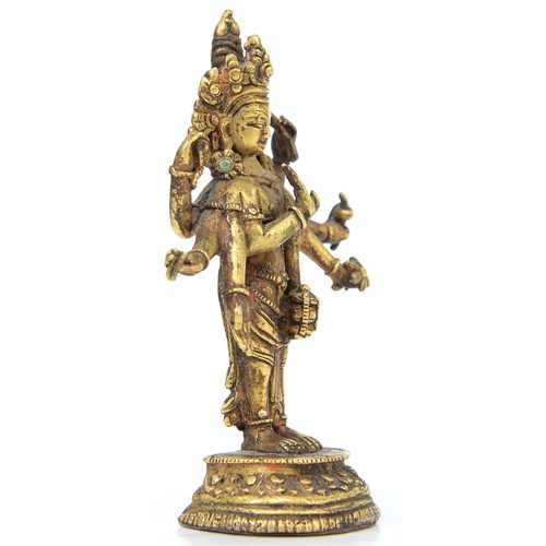 330 - A Tibetan miniature gilt bronze figure of  Vasudhara (Tara), 19th c, sealed, 10cm h