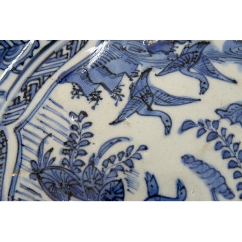 260 - A Chinese Kraak porcelain blue and white dish, c1630-1650, painted to the centre with two geese at t... 