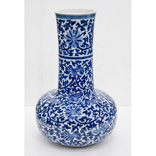 159 - A Chinese blue and white bottle shaped vase, 20th c, painted in Ming style with lotus meander, 40cm ... 