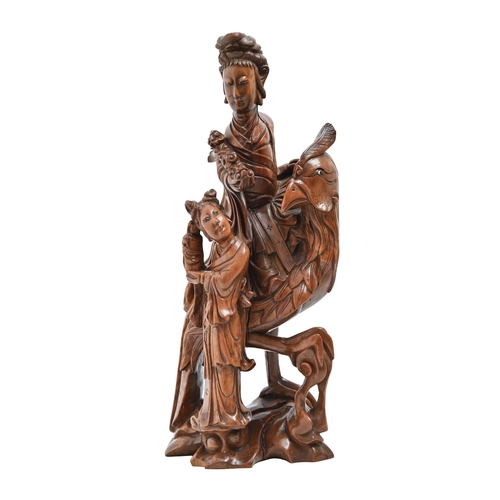 852 - A Chinese rootwood carving of Guanyin, early 20th c, on a phoenix with attendant, glass bead eyes, 4... 