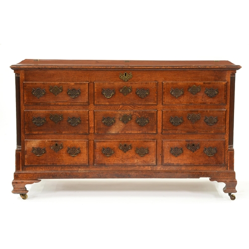1219 - A George III oak mule or 'Lancashire' chest, the crossbanded lid with three brass hinges, the front ... 