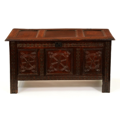 1222 - A Charles II oak chest, with three-panel lid, the three panels to the front carved with 'tulip' roun... 
