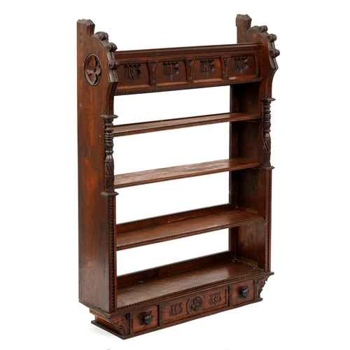 1223 - A Victorian reformed gothic oak hanging bookcase, the frieze carved with initials W M A C, the base ... 